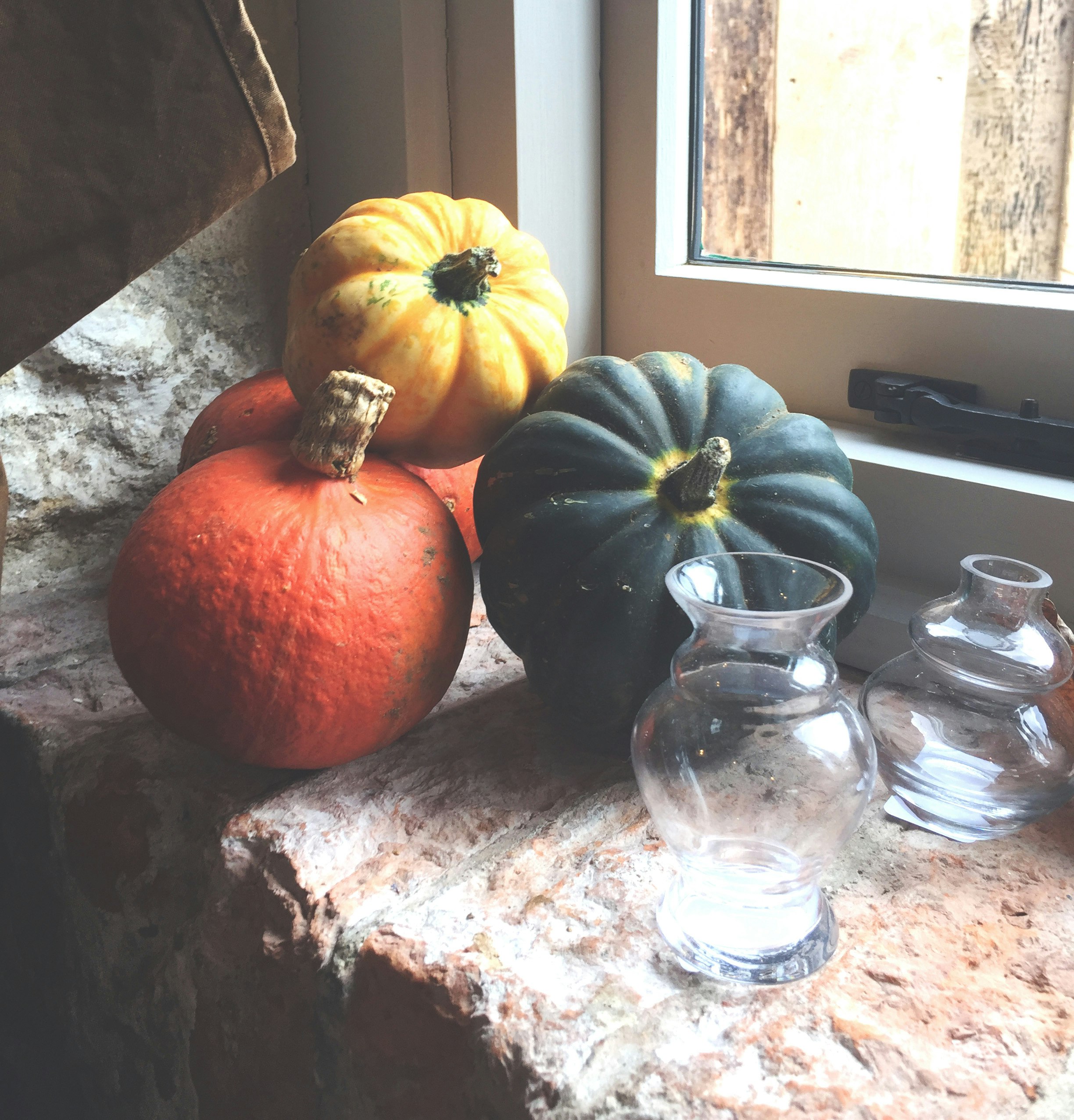 orange pumpkin beside clear glass jar